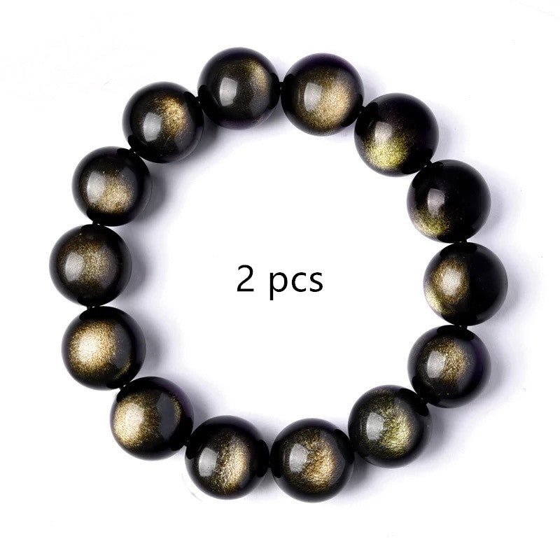 Detail shot of Black gemstone Gold Sapphire Bracelet with round beads, highlighting black and gold colors on a white backg…