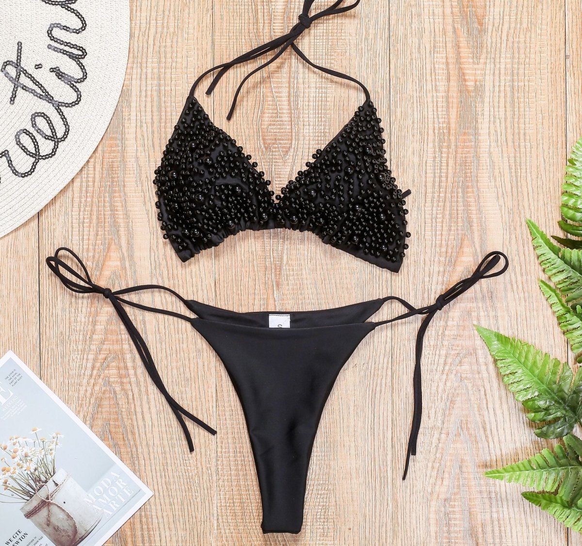 Detail view of the black halter mini bikini swimsuit with triangle cups, elegant and stylish design.