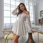Lifestyle shot of a white hollow-out off-shoulder dress with long sleeves, elegant and chic style.