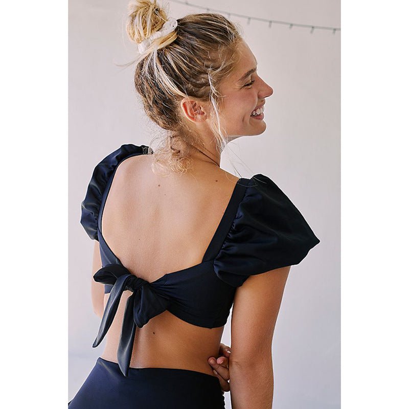 Back view of the black ruffled bikini featuring an open back, stylish and chic.