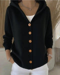 Front view of the black cotton cardigan with button closure and long sleeves, sophisticated minimalist design.