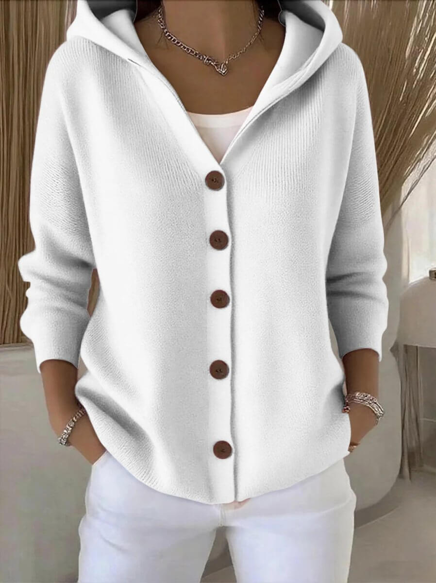 Front view of the white cotton cardigan featuring button closure and long sleeves, chic minimalist style.