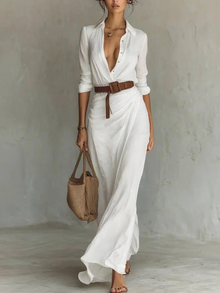 Lifestyle shot of a white long dress showcasing a belted waist and button lapel, chic fashion for any occasion.