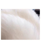 Close-up detail of soft white knitted fabric showcasing its texture.