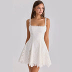 Front view of the white lace-trimmed backless mini dress, showcasing its chic and feminine design.