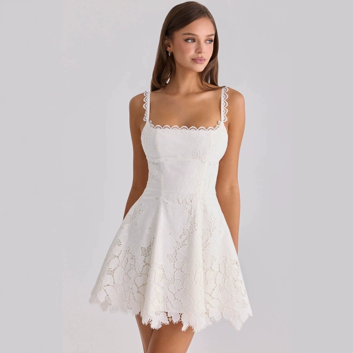 Front view of the white lace-trimmed backless mini dress, showcasing its chic and feminine design.