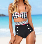 Lifestyle image of the red high-waist swimsuit featuring checkered pattern and button details.