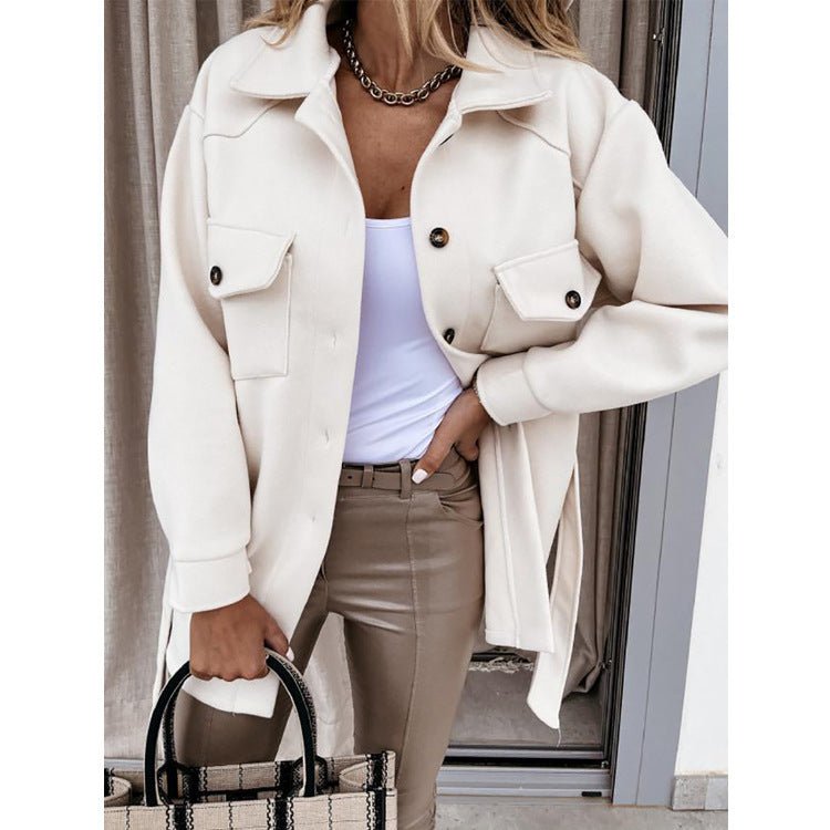 Beige lapel jacket with belted waist, single-breasted design in lifestyle setting.