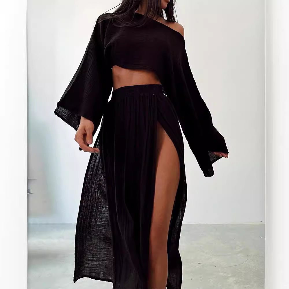 Chic black two-piece suit featuring an off-shoulder top and high slit skirt in a lifestyle shot.