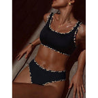 Lifestyle shot of the leopard print two-piece swimsuit with ruffled edges and adjustable straps.