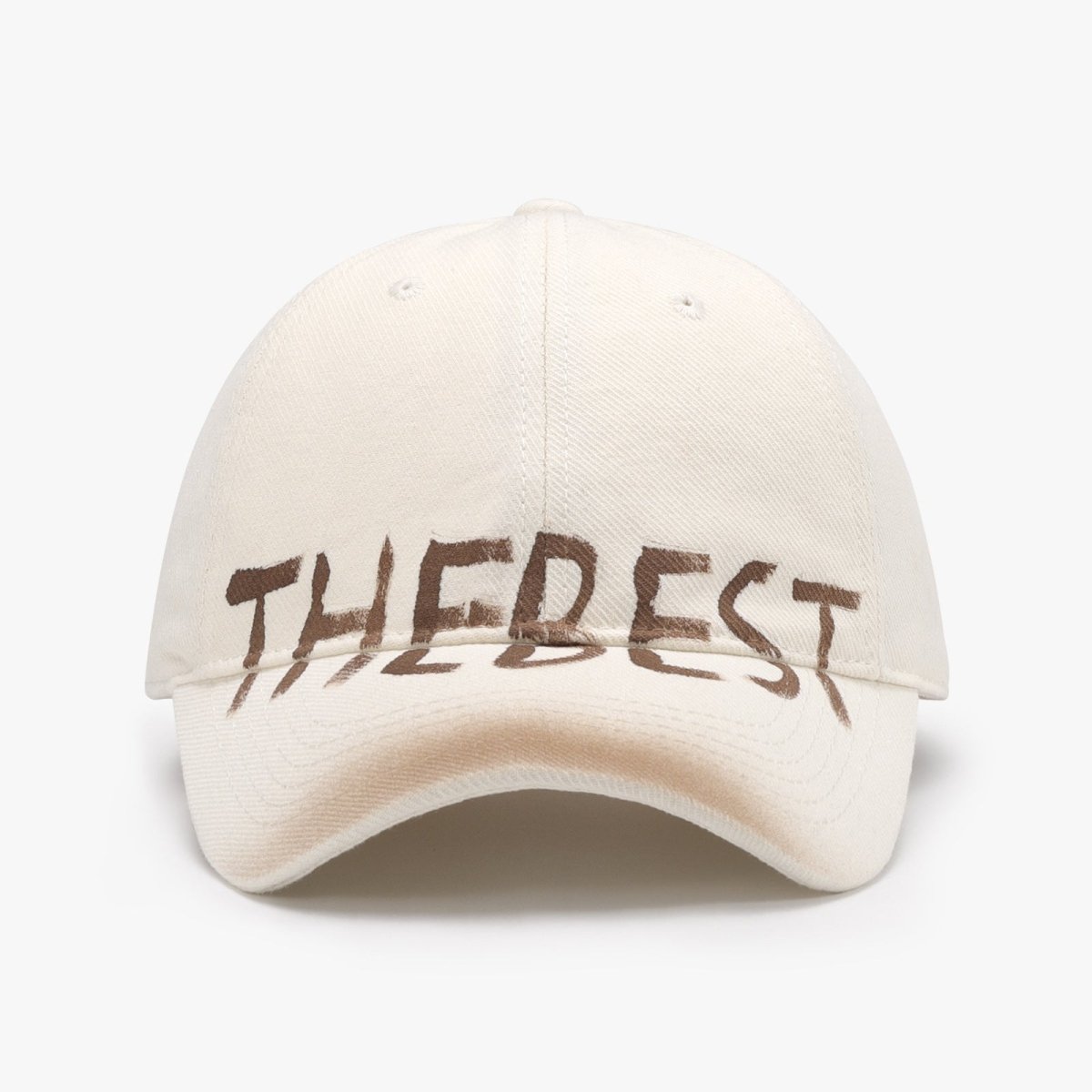 Front view of a cream adjustable cotton blend cap with graffiti design, versatile for minimalist outfits.