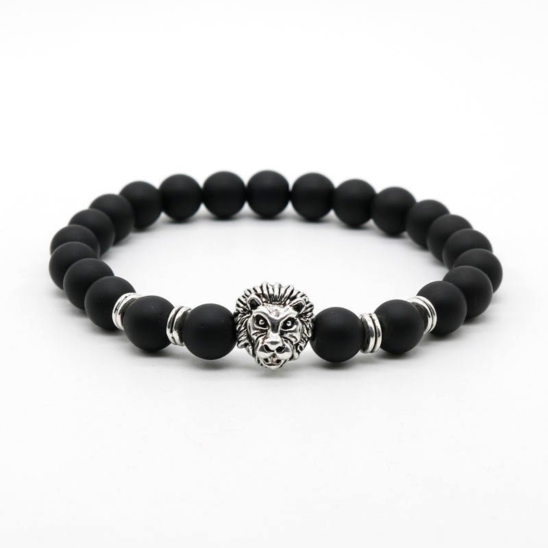 Detail close-up of the black stone bracelet showcasing a lion charm, elegant beaded style.