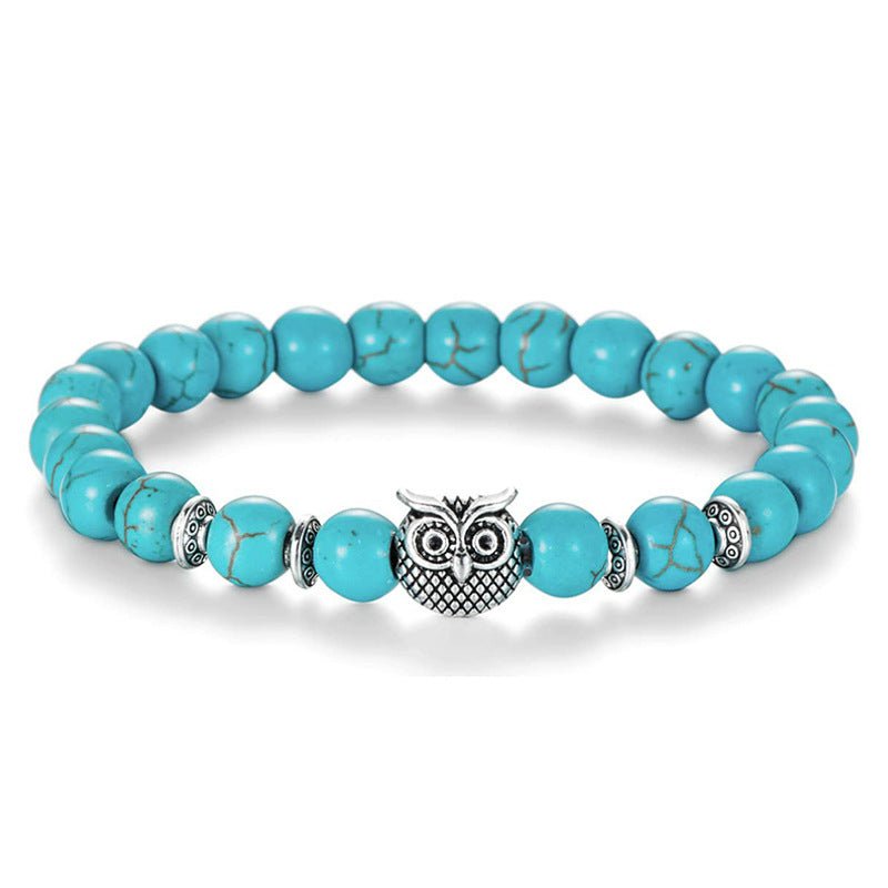 Detail close-up of the black stone bracelet with a lion charm, perfect for a chic outfit.