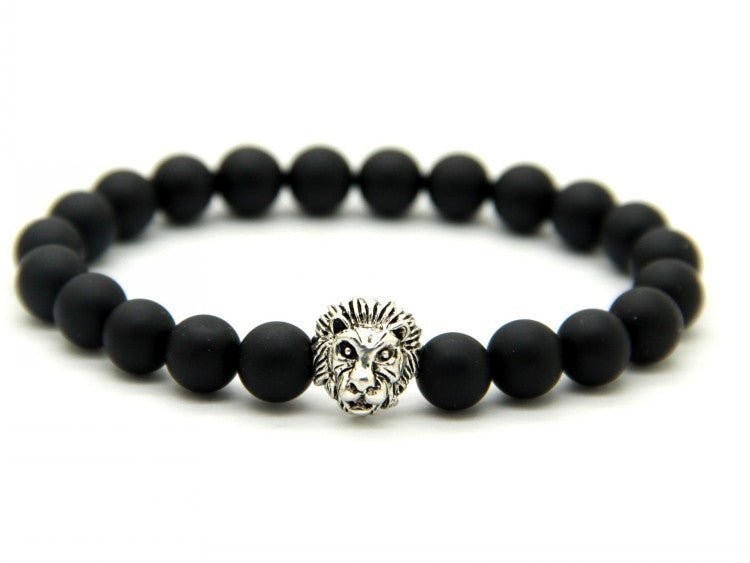 Detail close-up of the black stone bracelet featuring a lion charm, chic minimalist design.