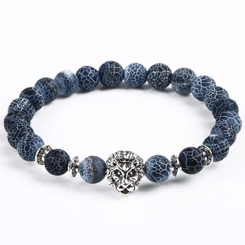 Detail close-up of blue stone bracelet with lion charm, showcasing beaded design on white background