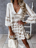 Back view of loose fit black and white geometric print dress, showcasing relaxed silhouette and v-neck design.