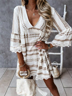 Back view of loose fit black and white geometric print dress, showcasing relaxed silhouette and v-neck design.