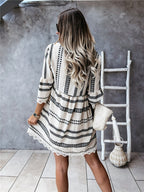 Back view of loose fit dress in beige and black geometric print, highlighting relaxed design and elegant cut.