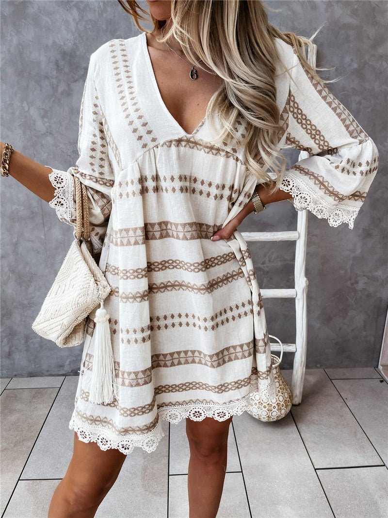 Lifestyle shot of beige and black geometric print dress, featuring long sleeves and chic minimalist style.
