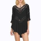 Chic black crochet beach cover-up with v-neck, lifestyle shot showcasing sophisticated style.