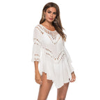 Stylish white crochet beach cover-up featuring long sleeves, lifestyle shot highlighting chic fashion.