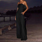 Black backless wide leg jumpsuit in a lifestyle shot, showcasing chic fashion outdoors.