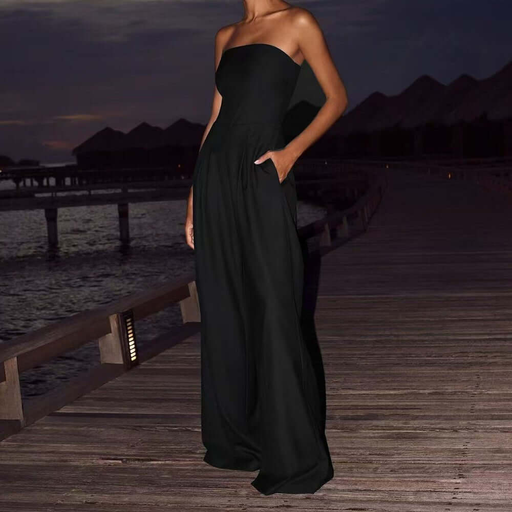Black backless wide leg jumpsuit in a lifestyle shot, showcasing chic fashion outdoors.