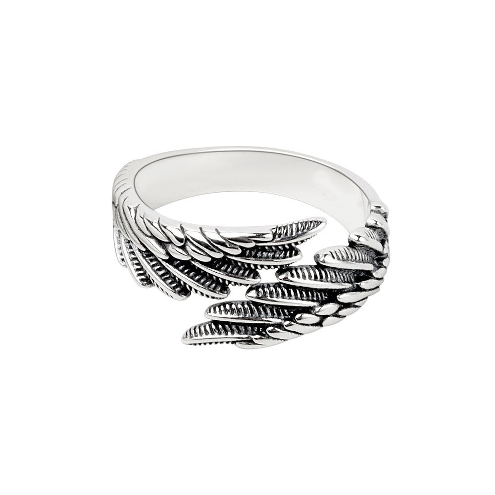 Close-up detail of the silver couple ring featuring the angel wings design on a neutral background.