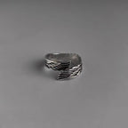 Close-up detail of the textured silver couple ring highlighting the angel wings design.