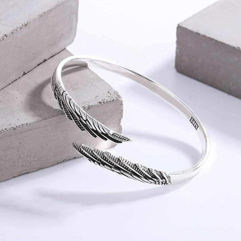Detail shot of the vintage silver couple ring highlighting the angel wings design against a white background.