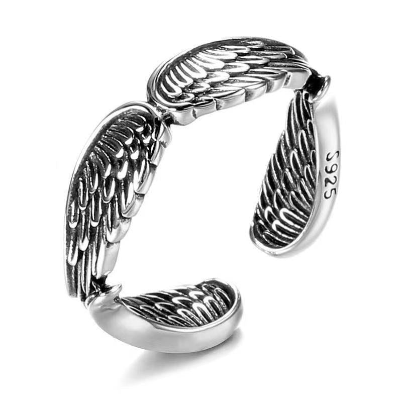 Close-up detail of the vintage silver couple ring featuring the angel wings design on a white background.