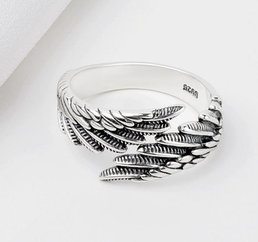 Detail shot of the silver couple ring showcasing the angel wings design against a white background.