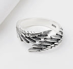 Detail shot of the silver couple ring showcasing the angel wings design against a white background.