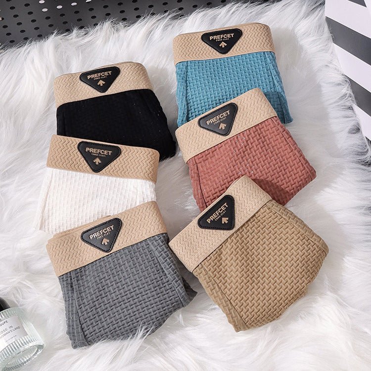 Lifestyle image of assorted boxer briefs in blue, black, and beige, showcasing multiple colors and a comfortable fit.