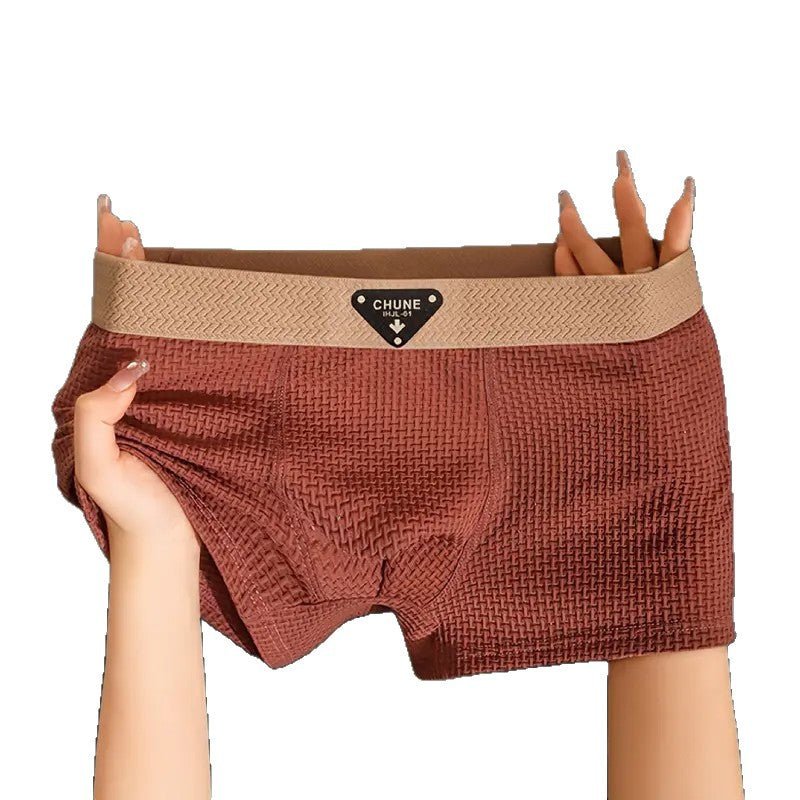 Lifestyle shot of brown boxer briefs with soft fabric and comfortable fit, displayed against a studio background.