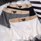 Lifestyle shot of various boxer briefs in black, gray, and white, featuring multiple colors and elastic waistband.