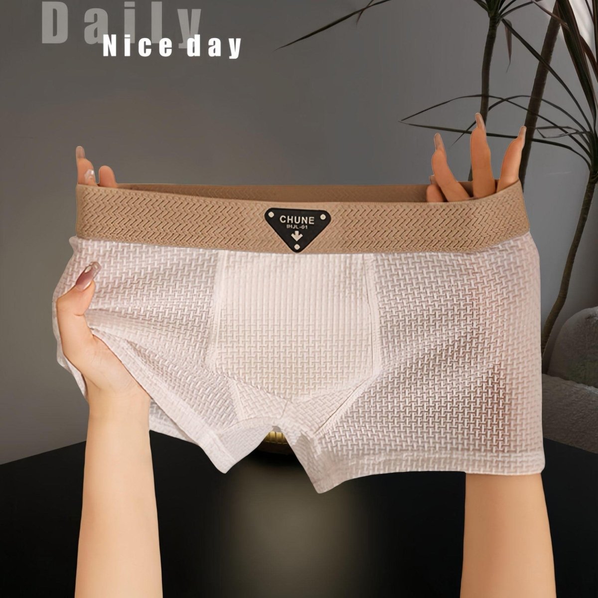 Detail view of white boxer briefs featuring elastic waistband and soft fabric, perfect for minimalist style.