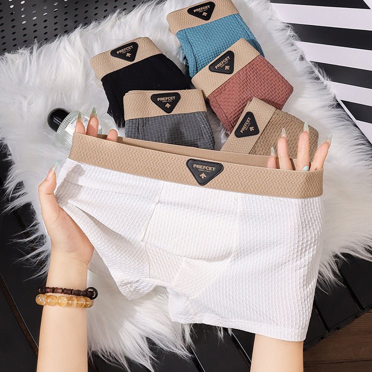 Lifestyle shot of white boxer briefs in soft fabric, showcasing a comfortable fit and various colors.