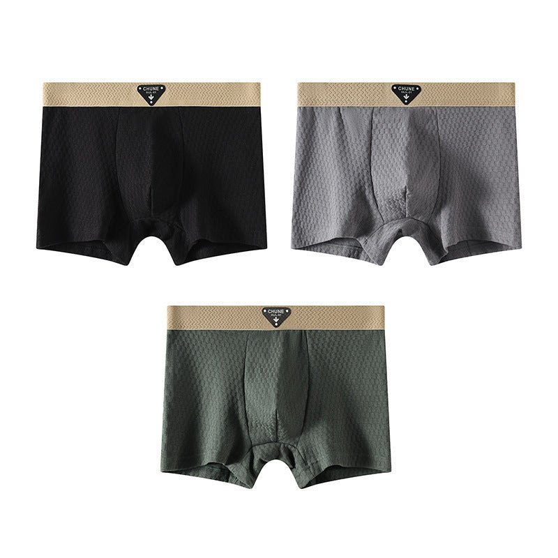 Packaging shot of boxer briefs assortment in black, blue, and gray, emphasizing variety and soft material.