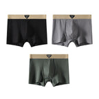 Packaging shot of boxer briefs assortment in black, blue, and gray, emphasizing variety and soft material.