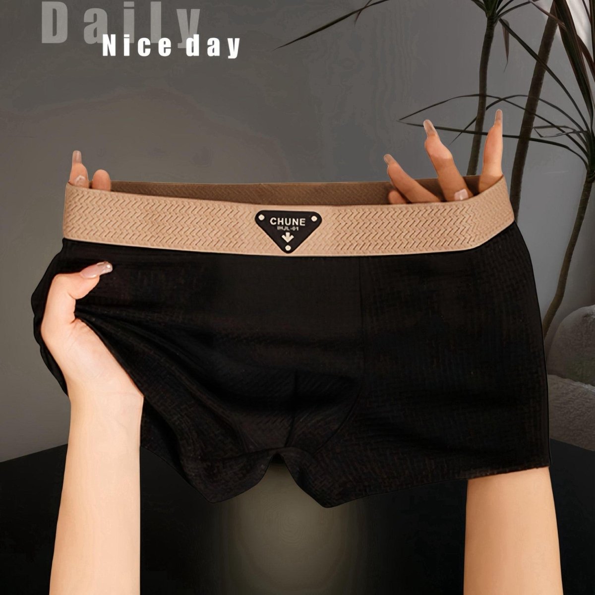Detail of black boxer briefs showcasing elastic waistband and soft fabric, ideal for everyday wear.