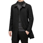 Lifestyle view of a black woolen coat featuring a lapel collar and mid-length cut against a white background.