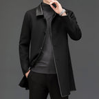 Lifestyle shot of a black woolen coat with lapel collar, mid-length, cashmere blend fabric in studio setting.