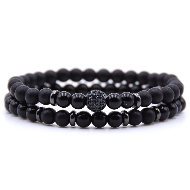 Detail close-up of black natural stone beaded bracelet with micro-inlaid zircon, elegant minimalist design for chic fashion.