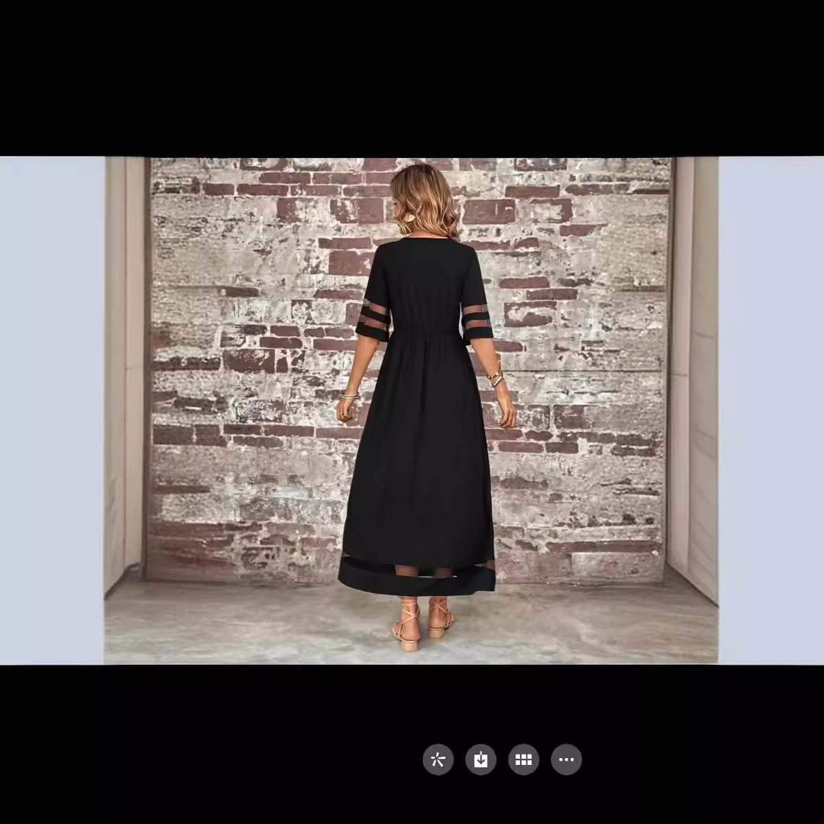 Back view of the black fishtail dress highlighting half sleeves and elegant design.