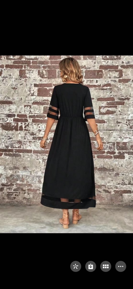 Front view of the black fishtail dress with half sleeves in a studio background, elegant and chic.
