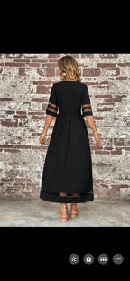 Front view of the black fishtail dress with half sleeves in a studio background, elegant and chic.