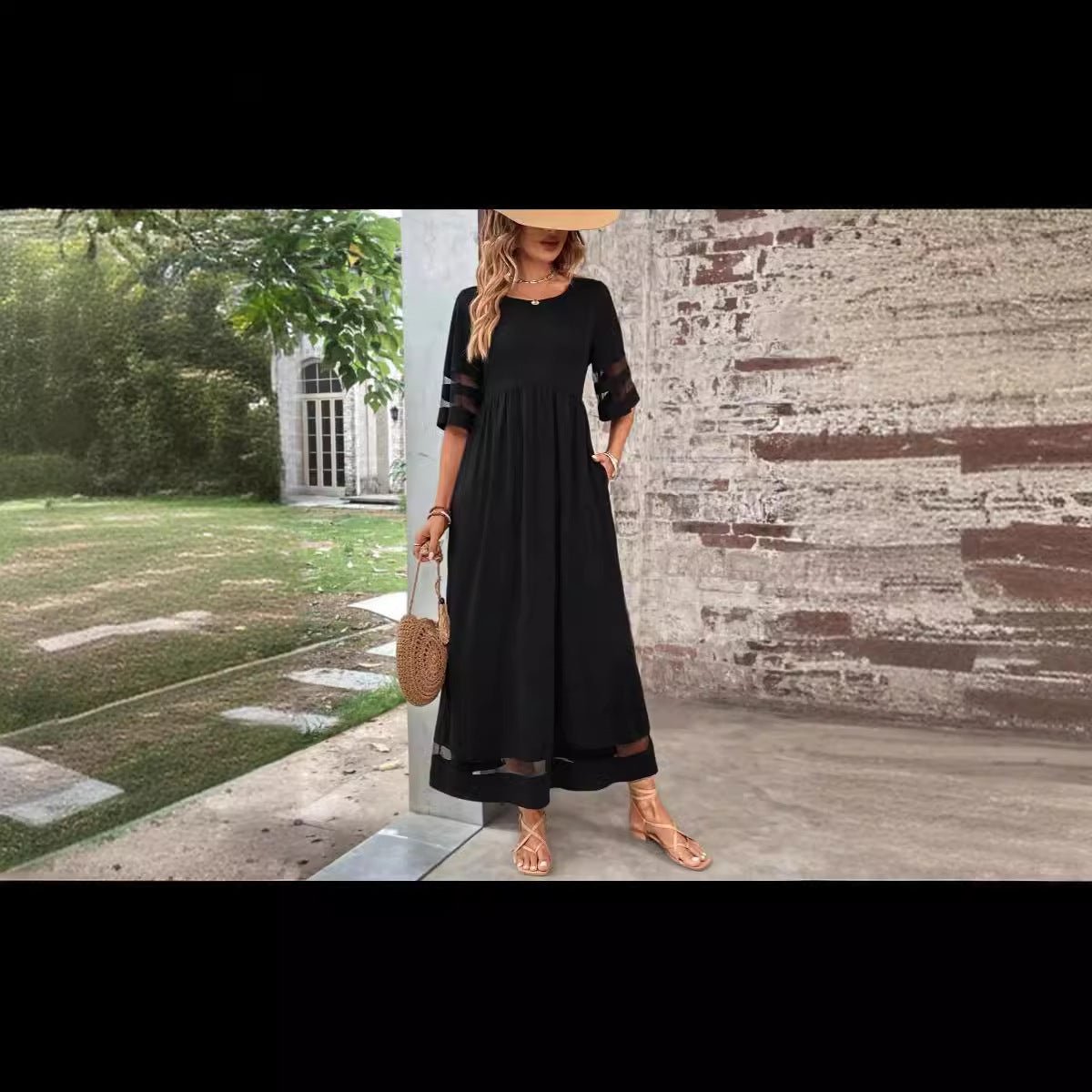 Black fishtail dress with half sleeves in a lifestyle setting, showcasing chic minimalist style.