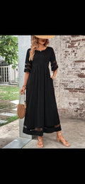 Black fishtail dress with half sleeves in a lifestyle setting, featuring a minimalist and elegant design.