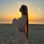 Beige one-shoulder dress in side view, emphasizing long sleeves and off-shoulder design.